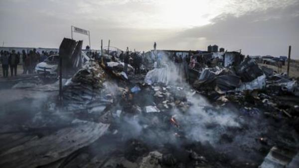 Palestinians look at the destruction after an Israeli strike where displaced people were staying in Rafah, Gaza Strip, Monday, May 27, 2024. 